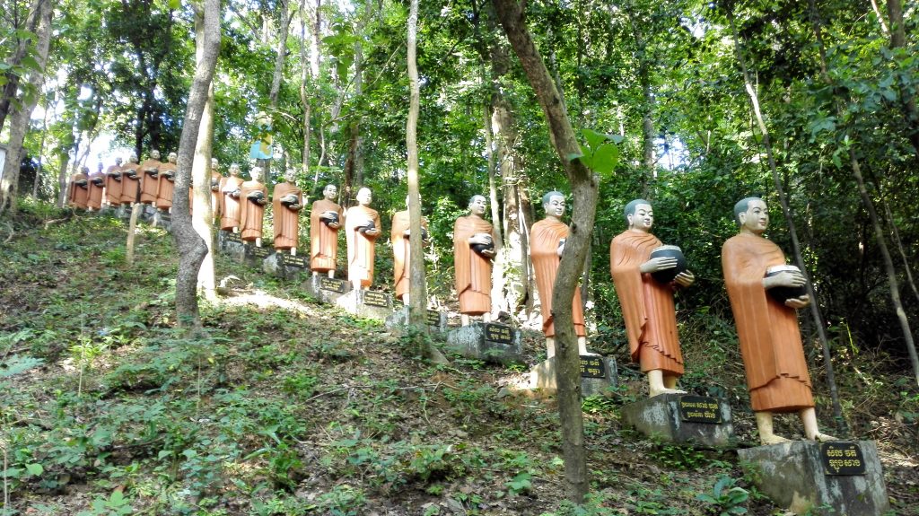 Row of Buddhist monk statues at Phnom Sambok in Kratie, Cambodia