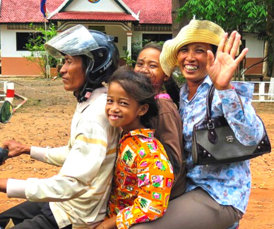 Smiling and waving locals in Siem Reap